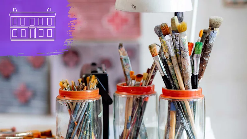 Art brushes in jar on desk