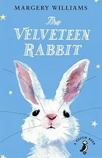 Book cover of the Velveteen Rabbit. Illustration of a rabbit on a light blue background with white stars.